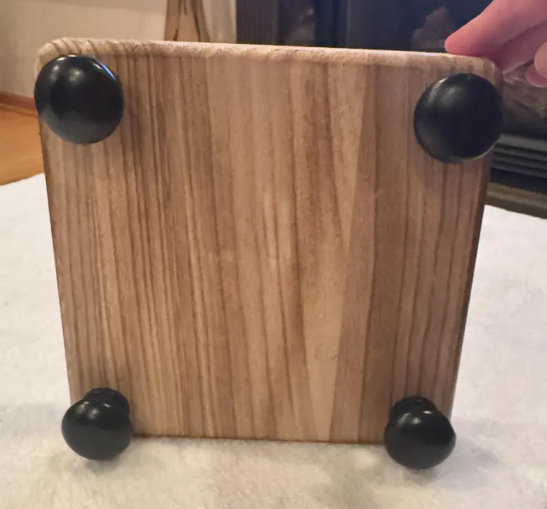 Wooden decorative shelf with black feet